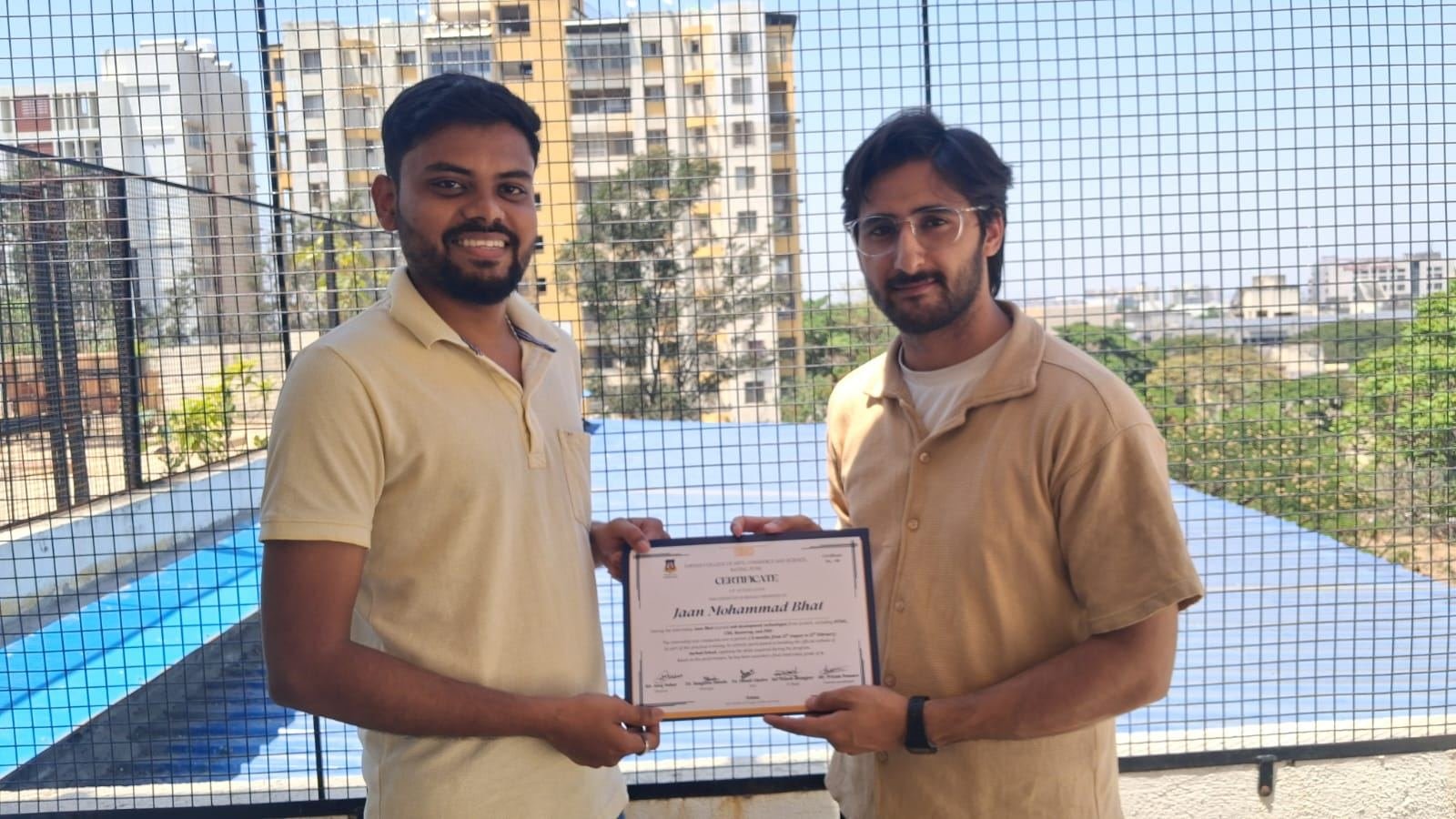 An intern receiving their completion certificate at TheOFCO