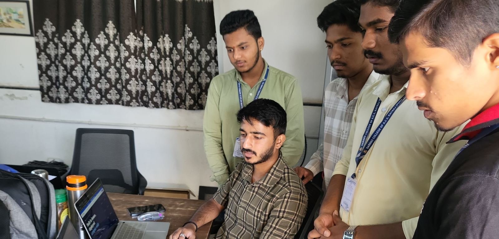 A TheOFCO mentor working through a build with a group of students